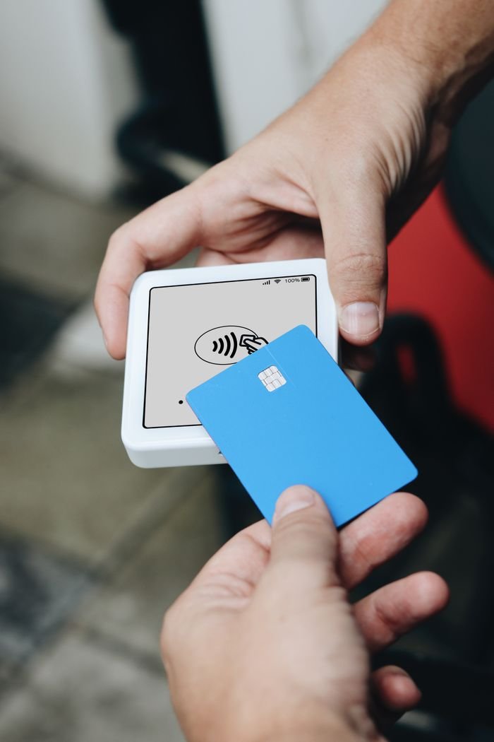 Home Hands using contactless payment terminal and credit card.